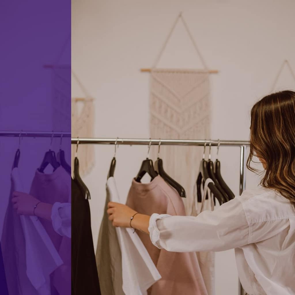 woman staring into open closet unable to choose an outfi