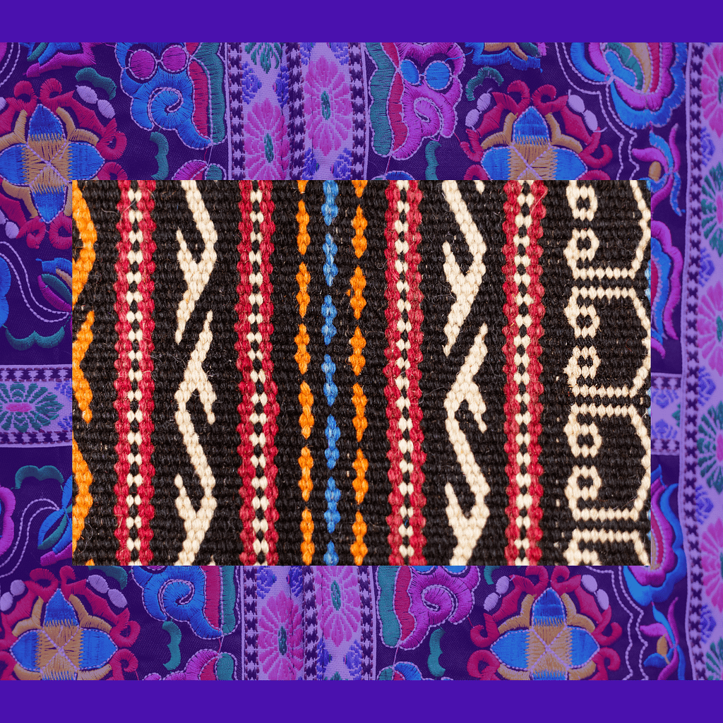 A piece of linen fabric with a bright embroidered print. African motif.